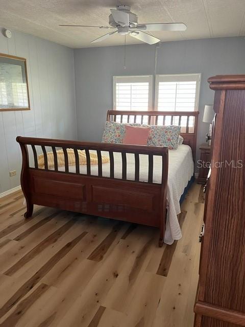 Master bedroom with newly installed waterproof vinyl plank flooring and plantation shutters.