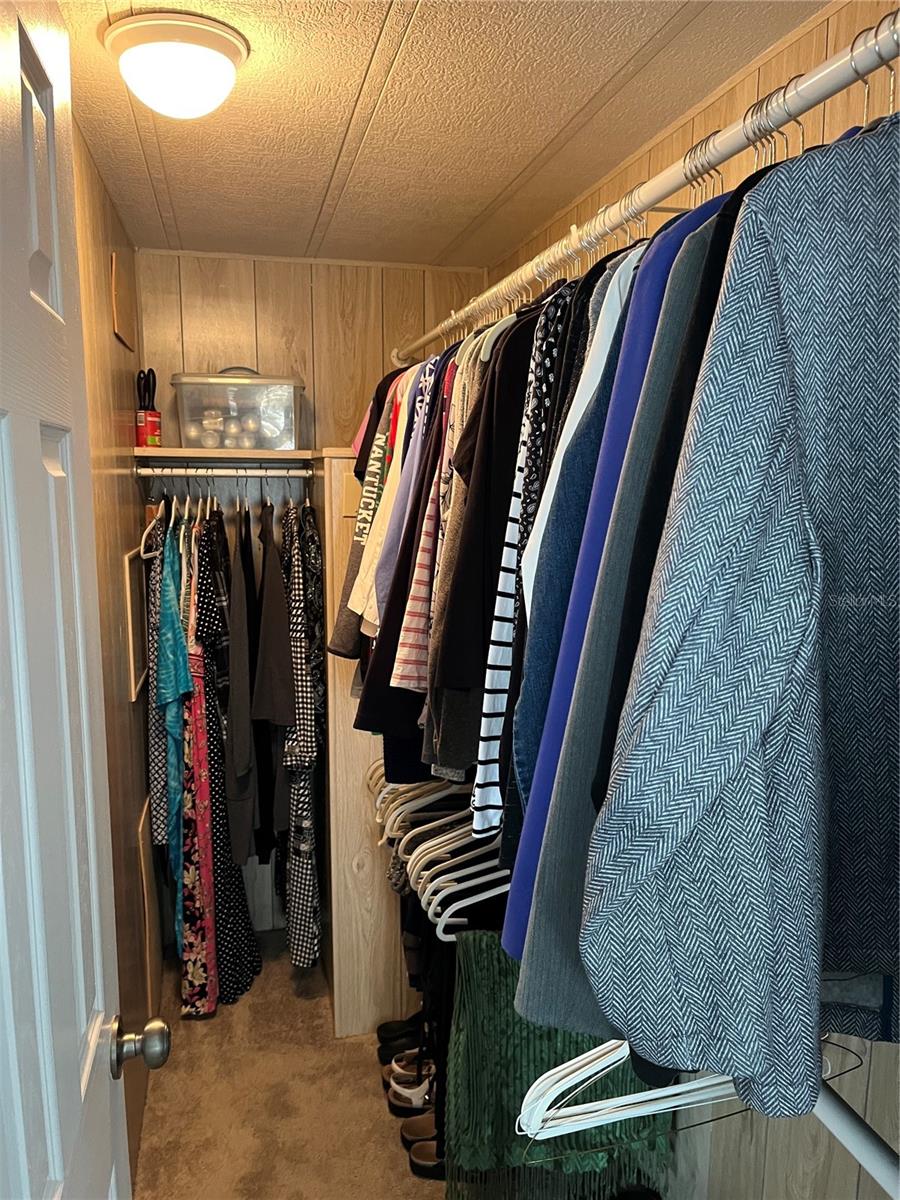 Large master bedroom closet before the new white paint, vary spacious.