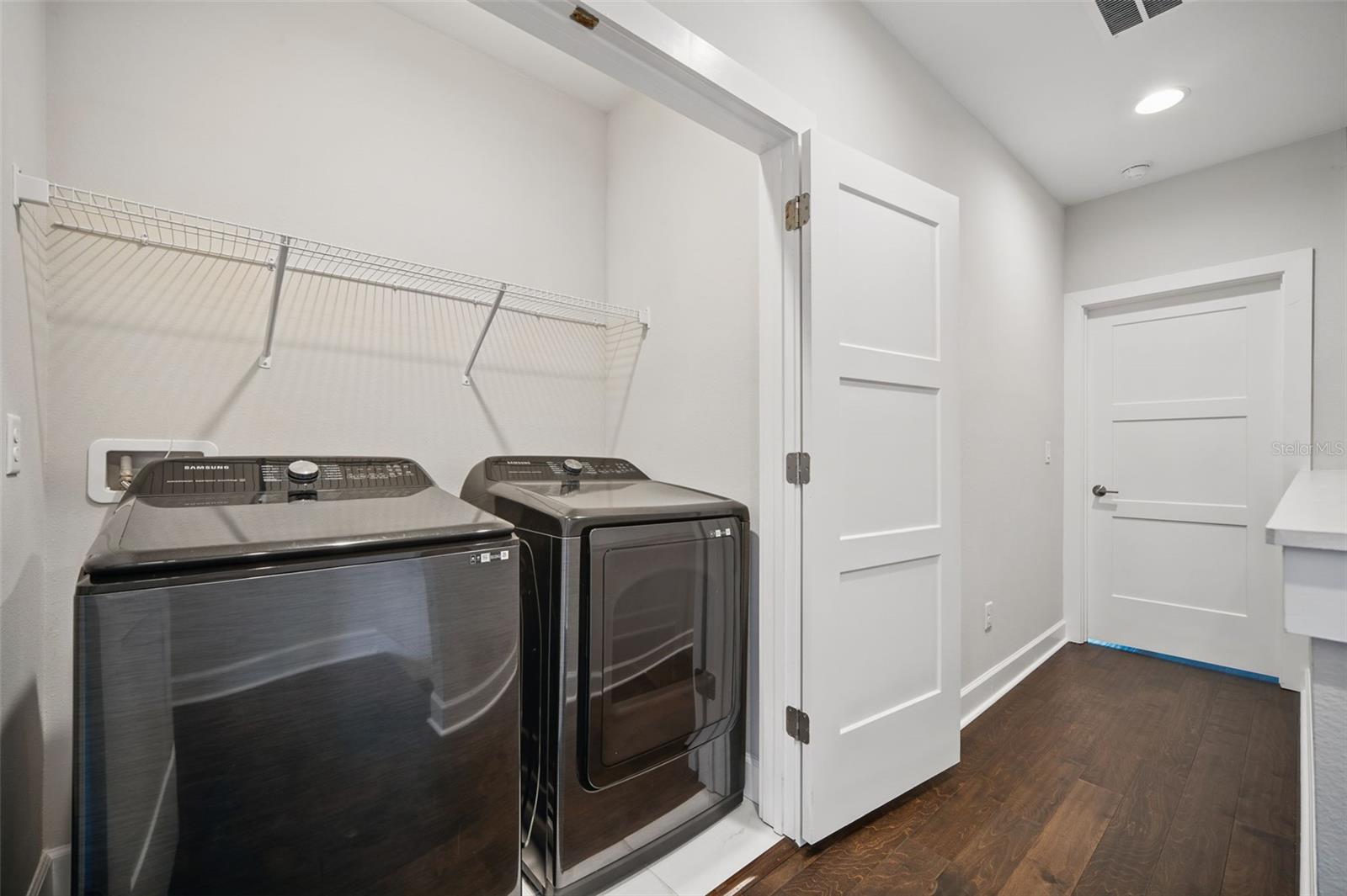 Upstairs laundry closet with upgraded washer and dryer