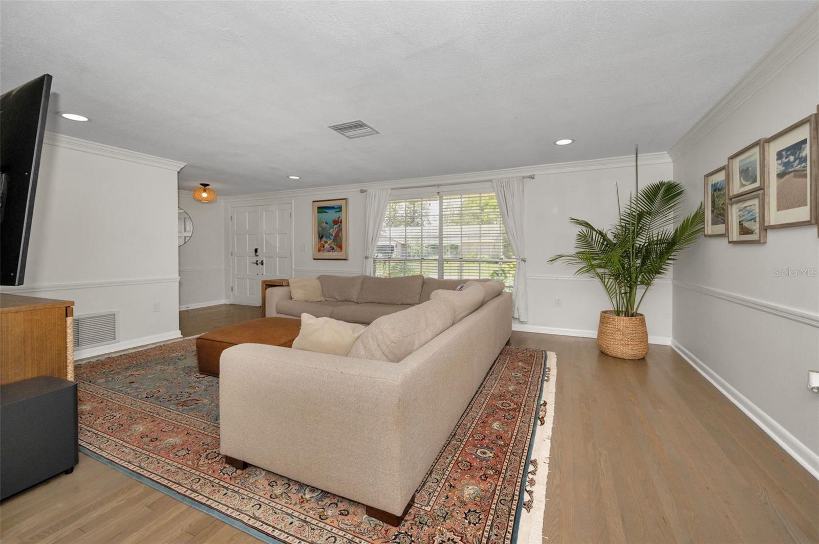 Crown molding, chair rail and engineered hardwood floors make the space feel elegant.