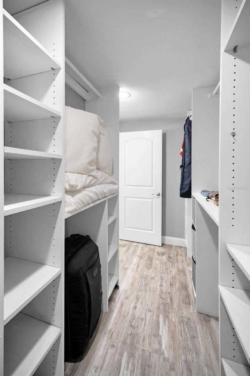 California style walk-in closet with tons of storage options.