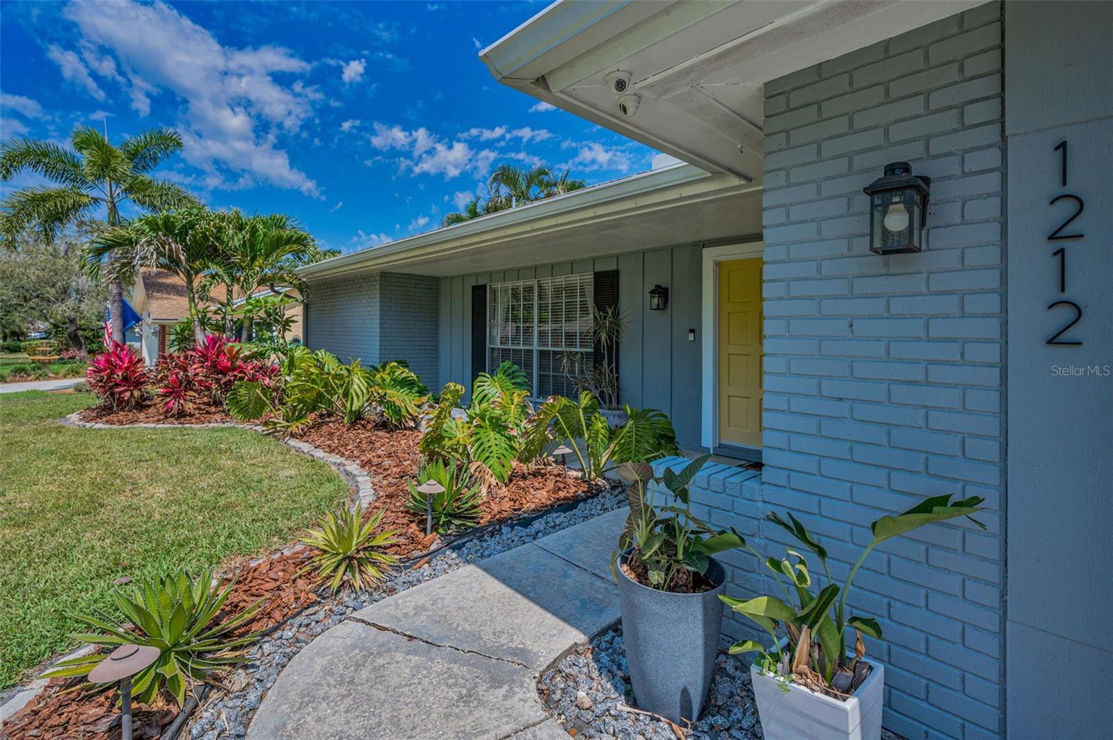 Painted brick, wood trim and shutters compliment this mid-century modern facade.