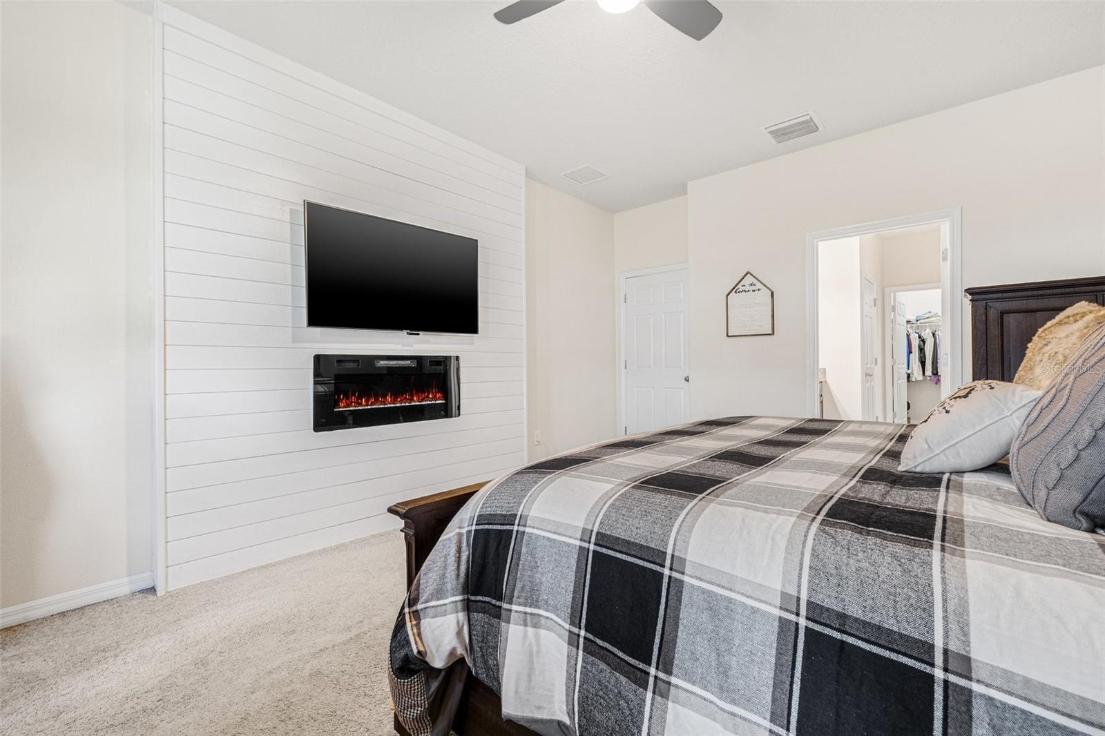Primary Suite with Shiplap Wall and Electric Fireplace