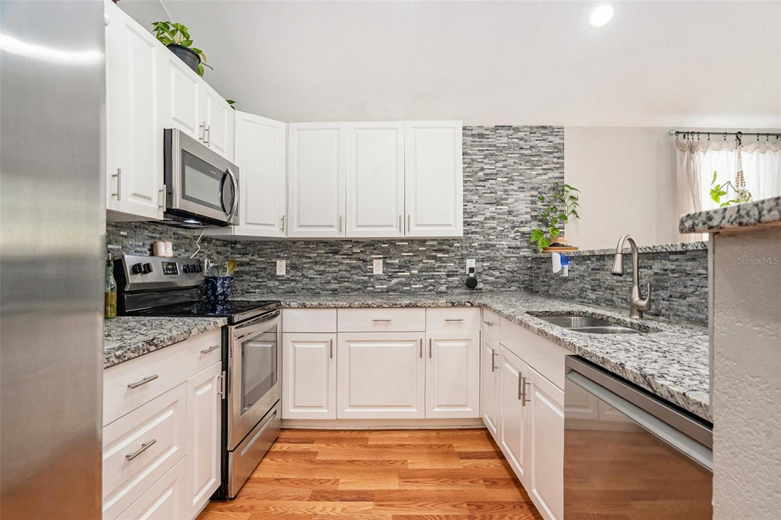 Gorgeous kitchen with granite countertops and a high bar top