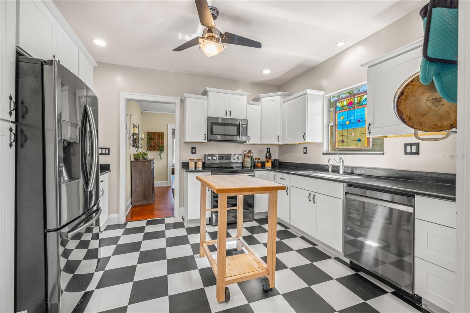 Kitchen with granite counters and stainless steel appliances.