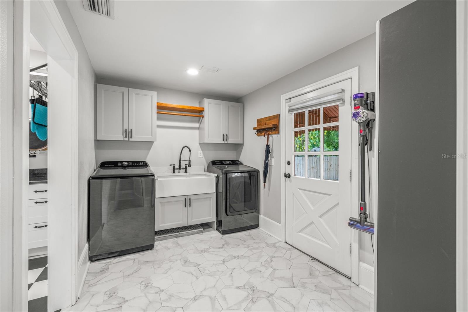 Laundry room is conveniently located near the primary bedroom and adjacent to the kitchen.
