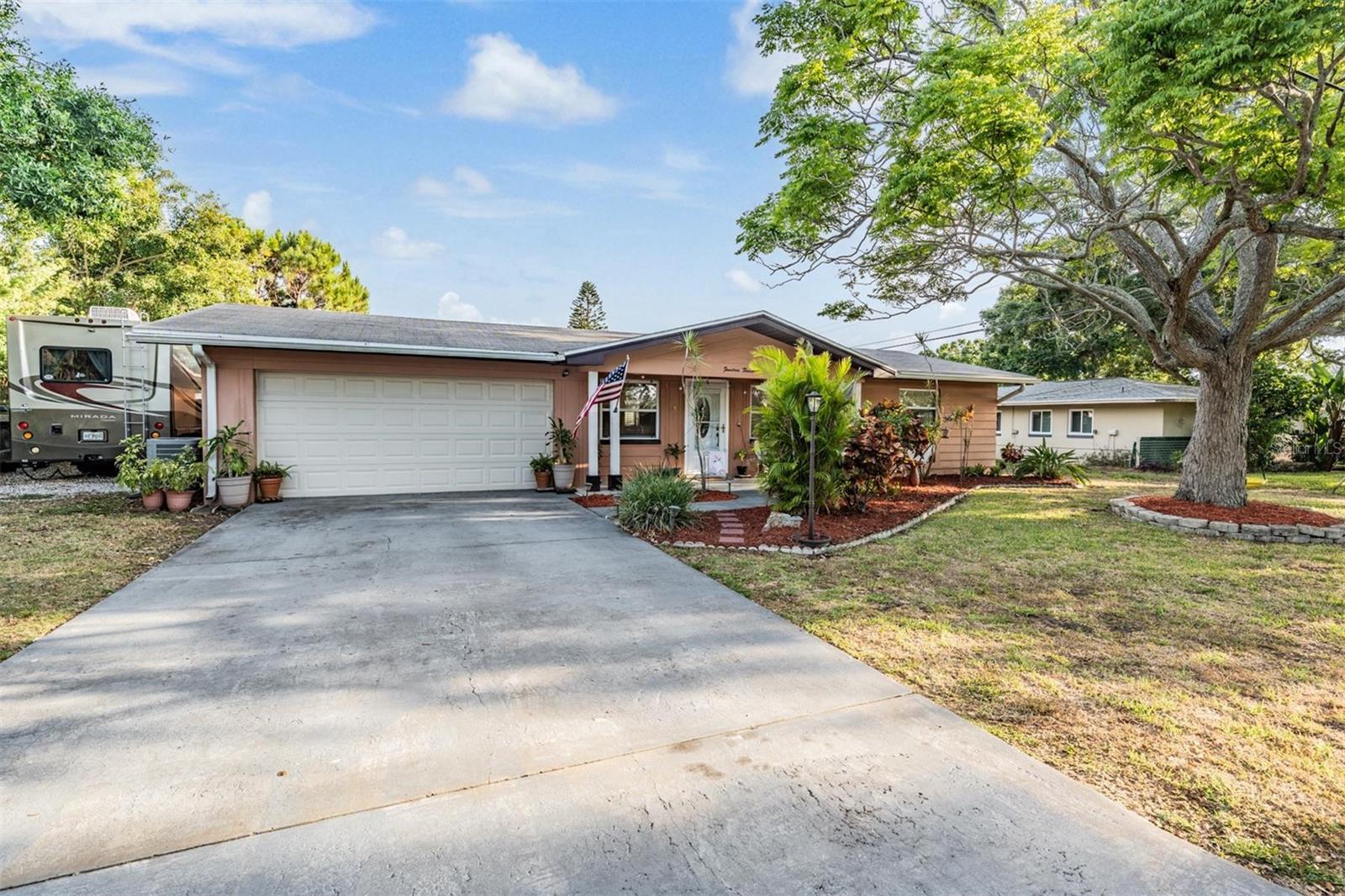 There’s no shortage of parking here—with a 2-car garage, a driveway that easily fits 4 vehicles, and a spacious side yard complete with a stone pad and 30-amp plug, perfect for a 30-foot boat, RV, or other toys.