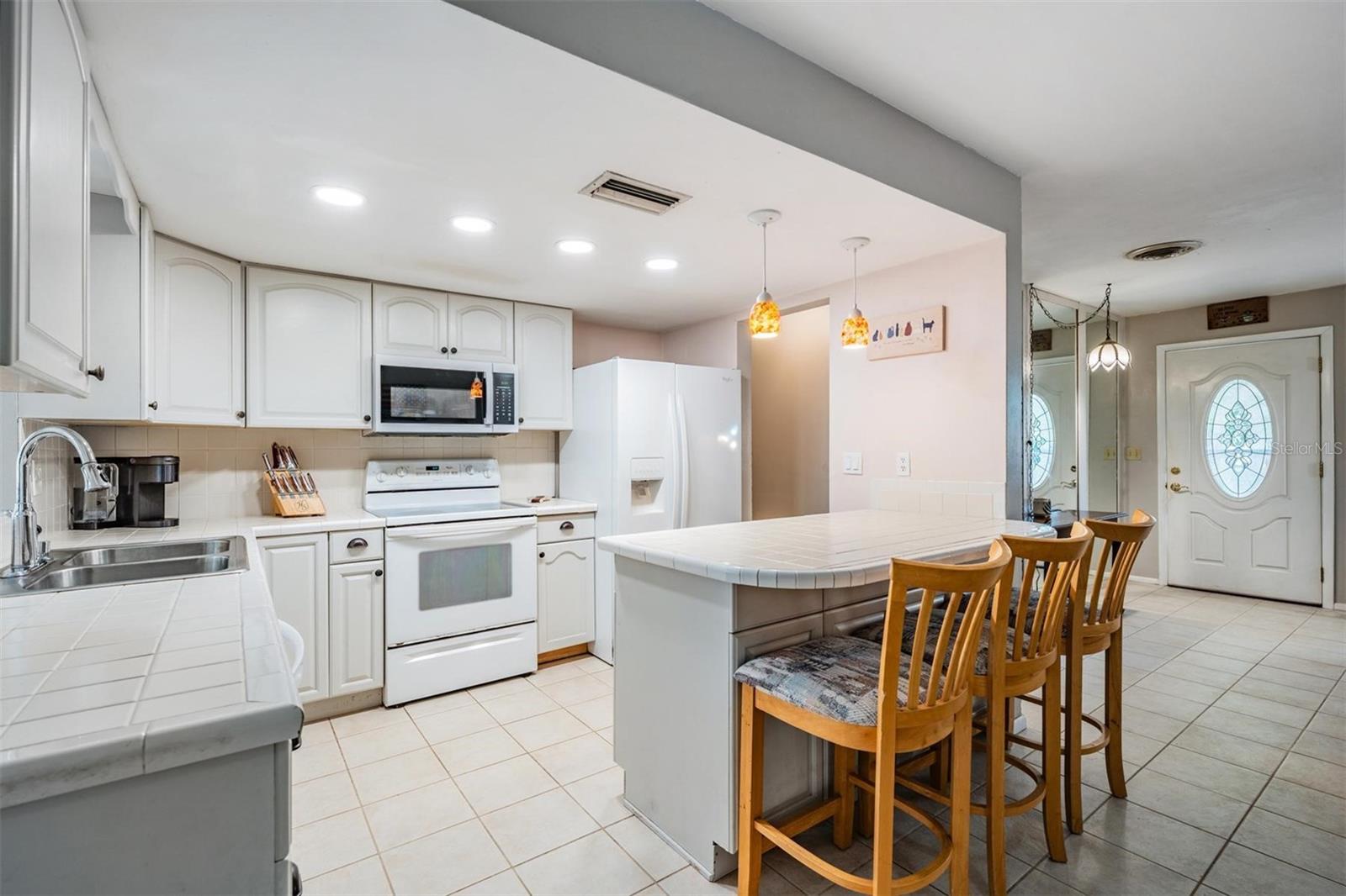 The light-colored kitchen creates a bright and airy atmosphere.