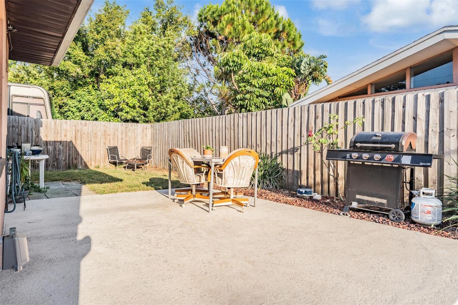 The outdoor patio area and grass lawn flow seamlessly into the side yard, extending your outdoor living space