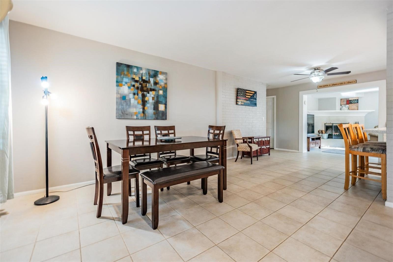 The living and dining areas flow seamlessly into the den, creating an open, inviting space that’s perfect for entertaining.