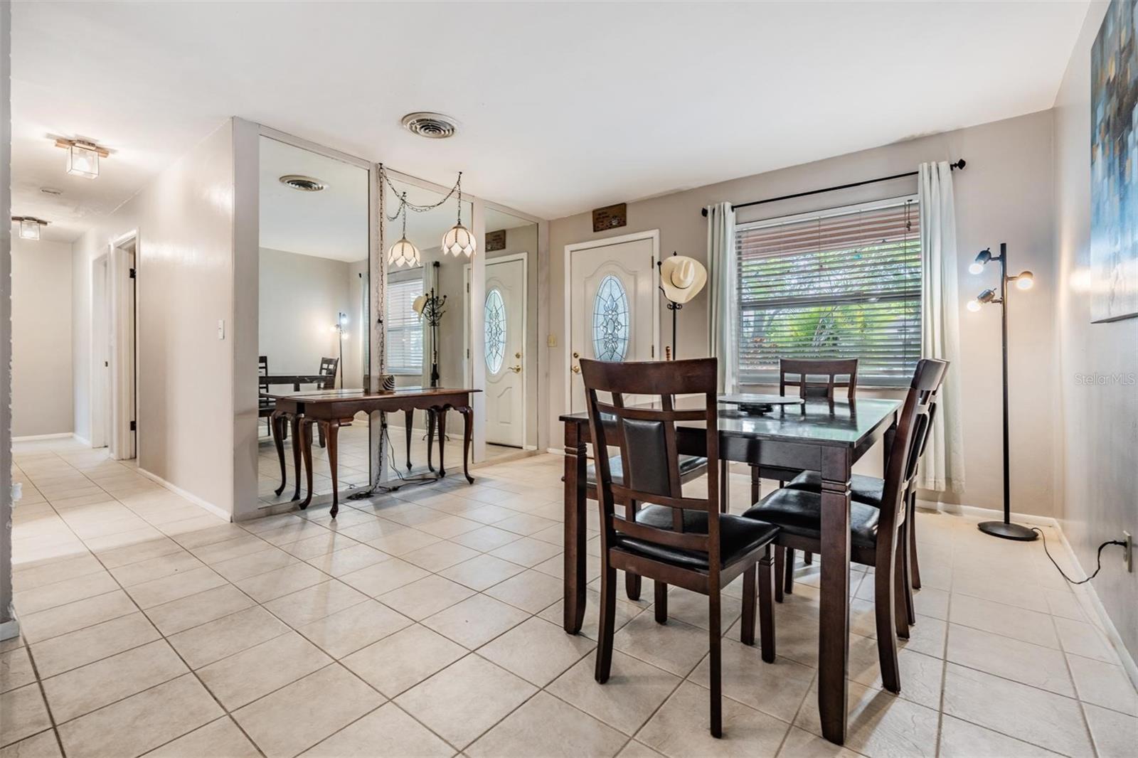 Down the hallway, you’ll find two bedrooms on the right, while the guest bathroom—with convenient pool access—and a third bedroom are located on the left.