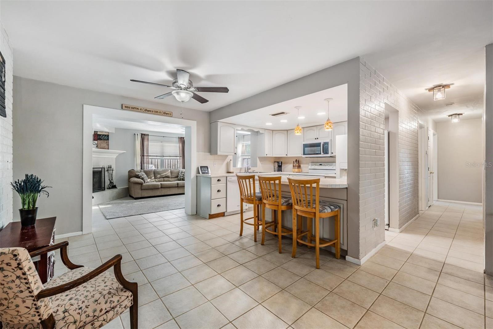 The dining area and kitchen snack bar offer ample space for casual meals or sit-down dinners.