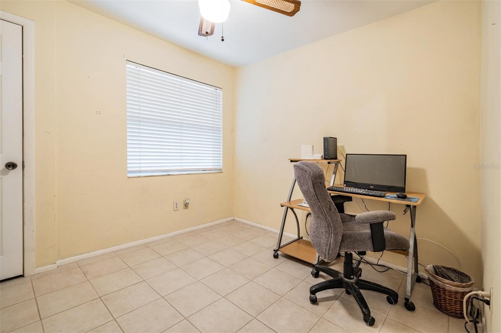The first bedroom is ideal for a home office, offering a quiet space to work or study.