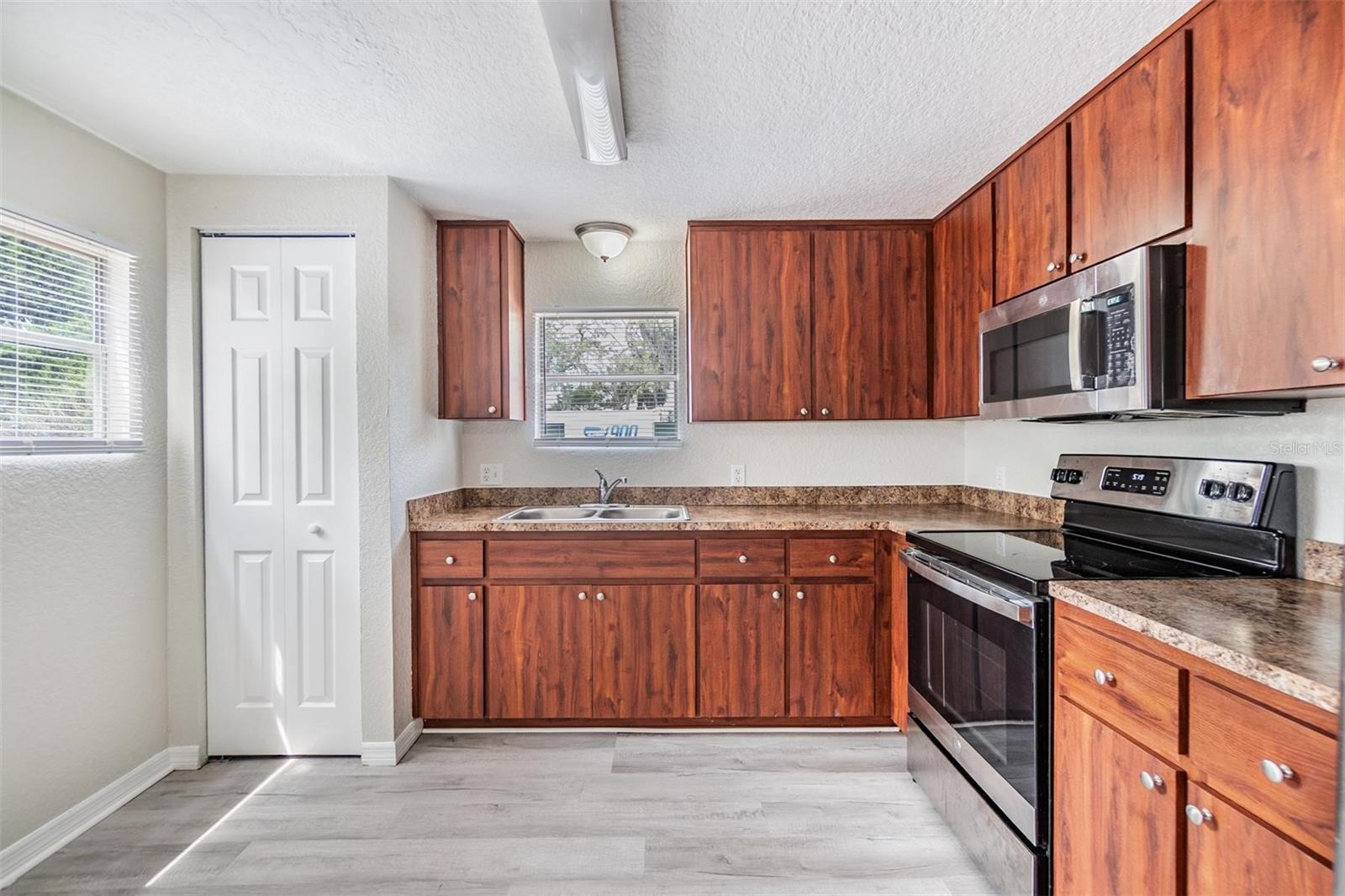 NEW LUX VINYL PLANK FLOORS. NO POPCORN CEILING.  DRYWALL ON WALLS.