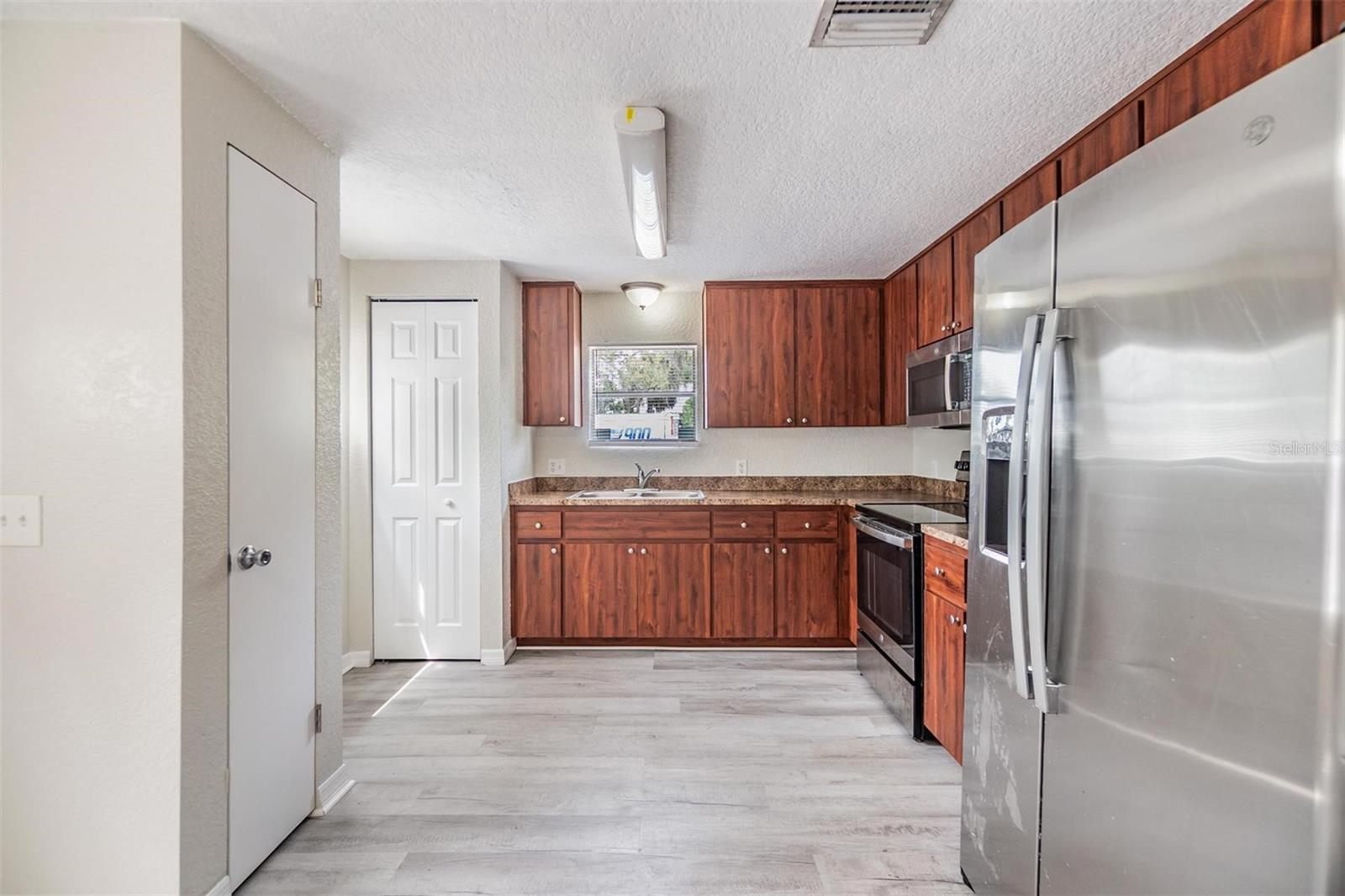 NEW LUX VINYL PLANK FLOORS. NO POPCORN CEILING.  DRYWALL ON WALLS.