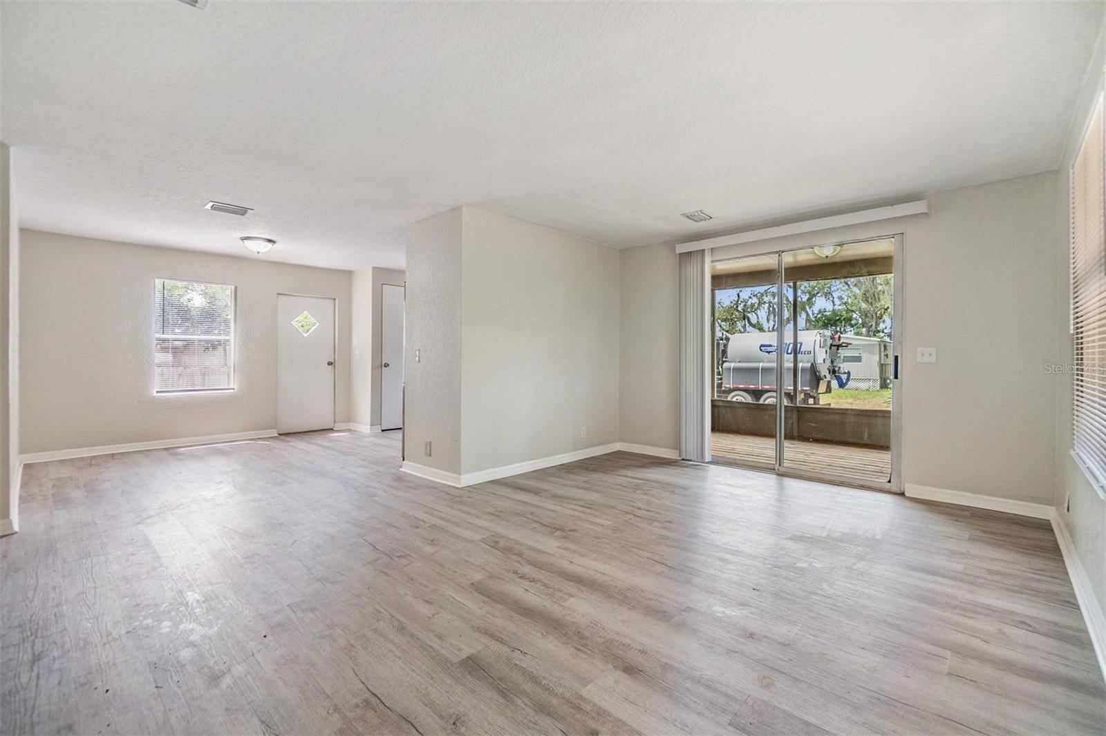 Living Room / Dining Room Combo.  NEW LUX VINYL PLANK FLOORS. NO POPCORN CEILING.  DRYWALL ON WALLS.