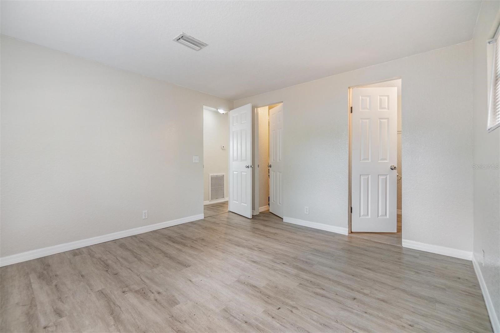Primary Bedroom with Bathroom. NEW LUX VINYL PLANK FLOORS. NO POPCORN CEILING.  DRYWALL ON WALLS.