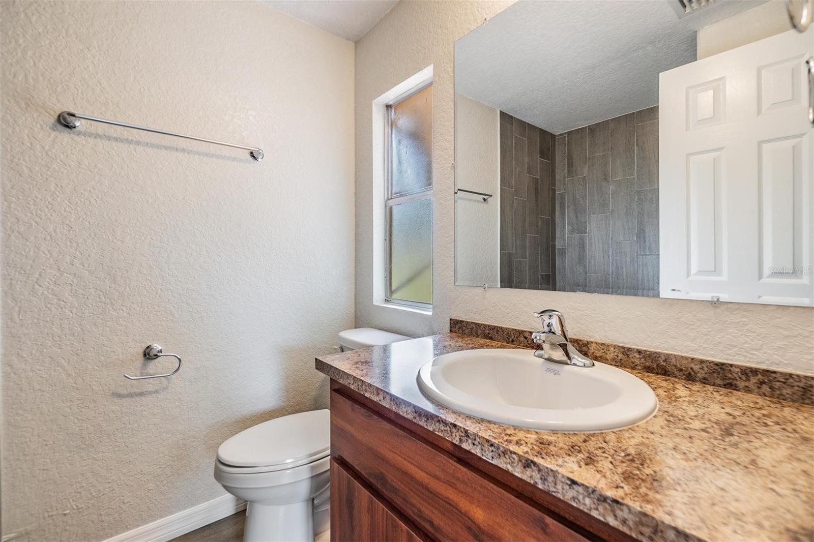 Primary Bedroom Bathroom.  NEW LUX VINYL PLANK FLOORS. NO POPCORN CEILING.  DRYWALL ON WALLS.