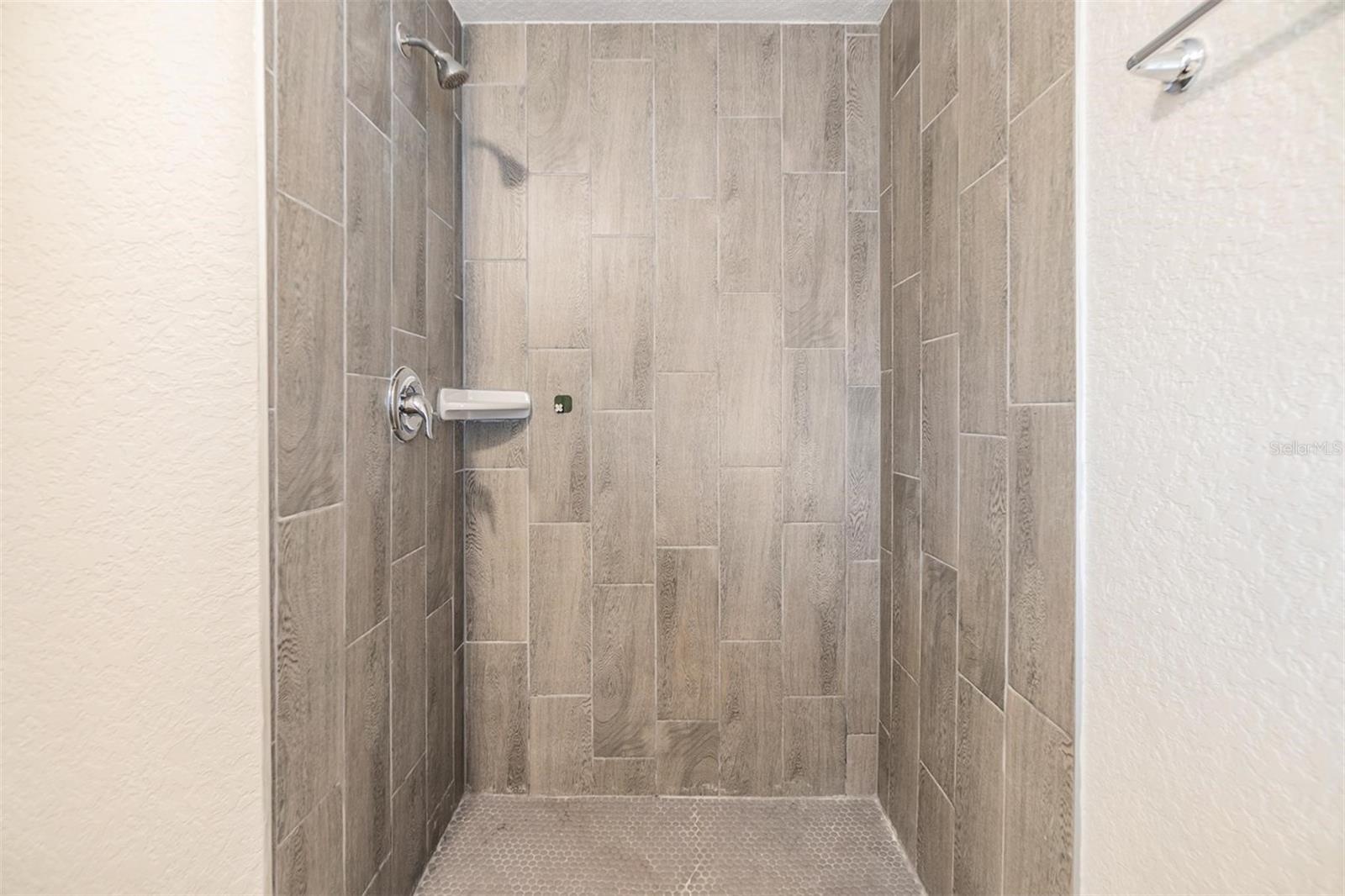 Primary Bedroom Shower.  NEW LUX VINYL PLANK FLOORS. NO POPCORN CEILING.  DRYWALL ON WALLS.
