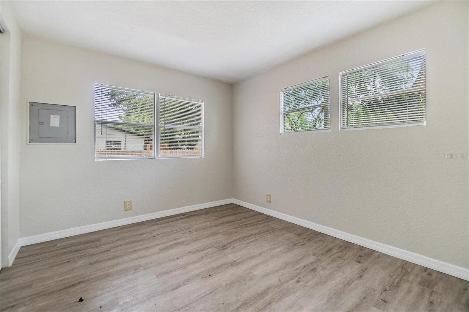 Bedroom #2.  NEW LUX VINYL PLANK FLOORS. NO POPCORN CEILING.  DRYWALL ON WALLS.
