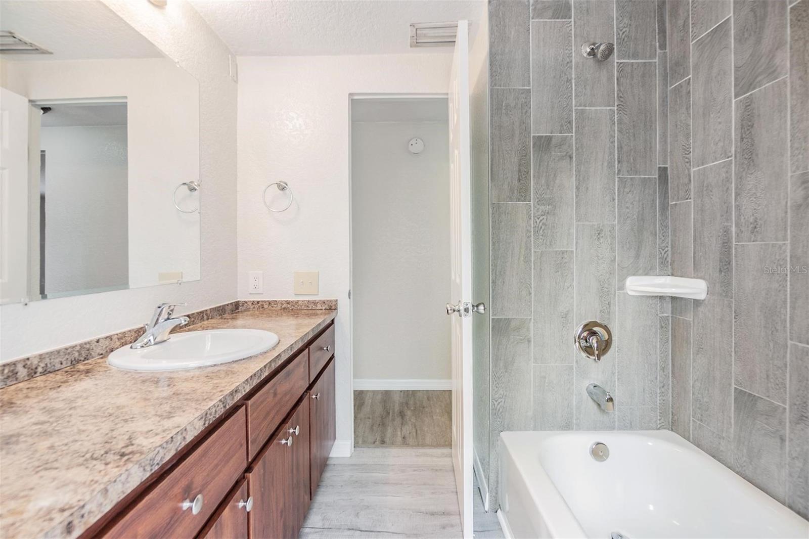 Community Bathroom.  NEW LUX VINYL PLANK FLOORS. NO POPCORN CEILING.  DRYWALL ON WALLS.