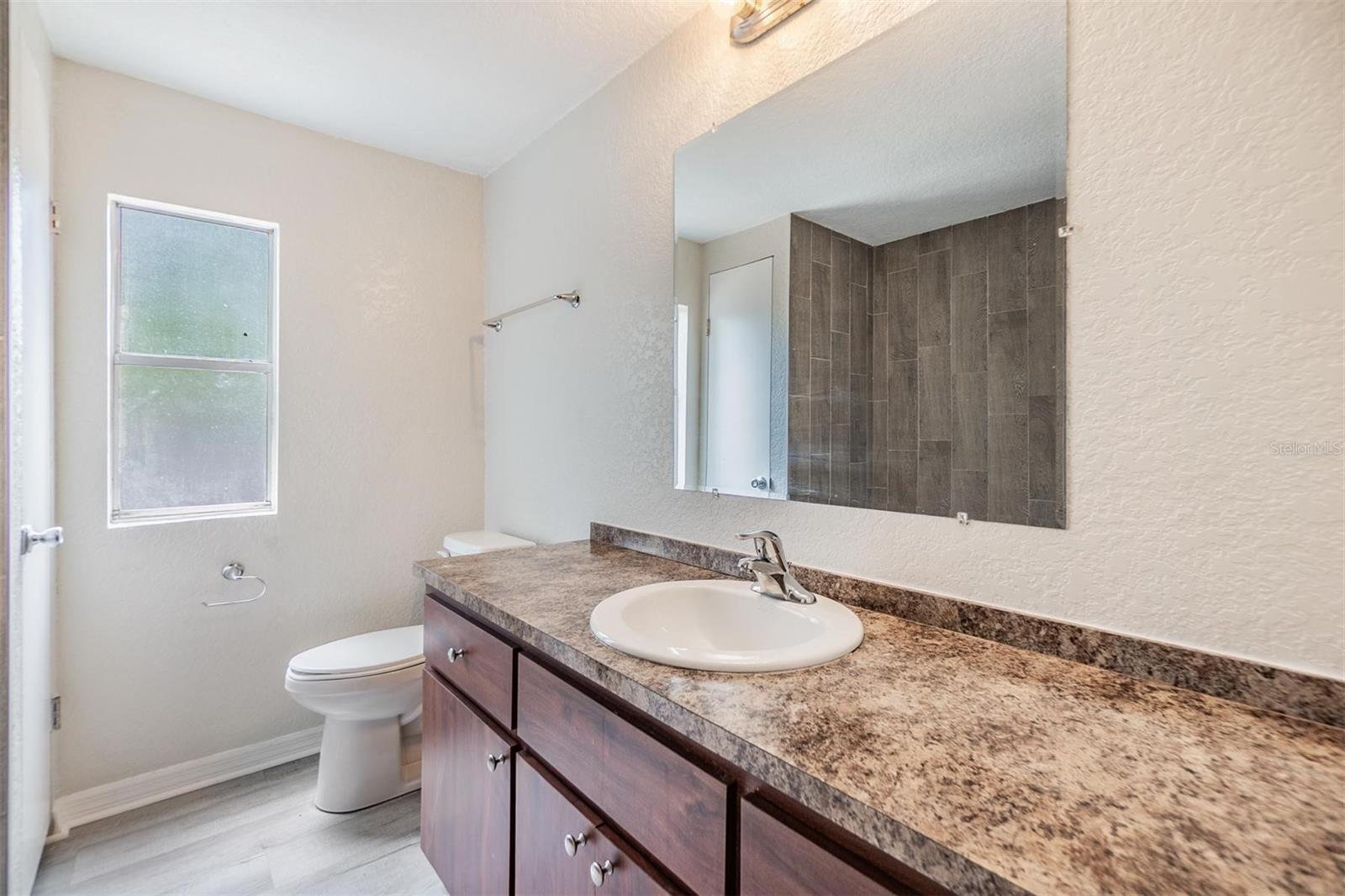 Community Bathroom.  NEW LUX VINYL PLANK FLOORS. NO POPCORN CEILING.  DRYWALL ON WALLS.