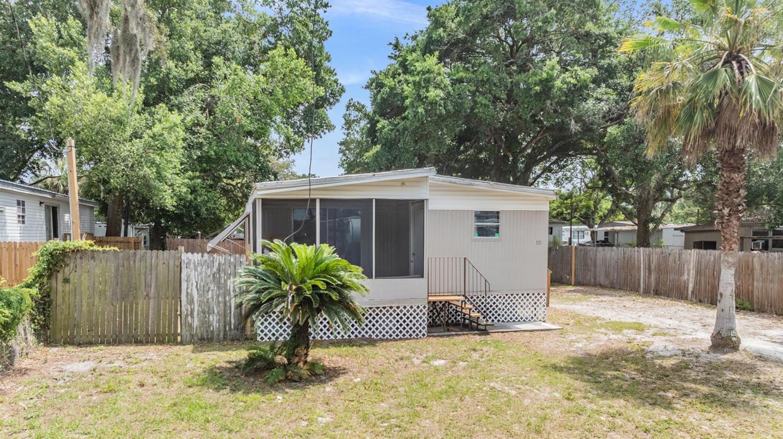 Front View of TWIN double wide mobile home. Fenced yard.