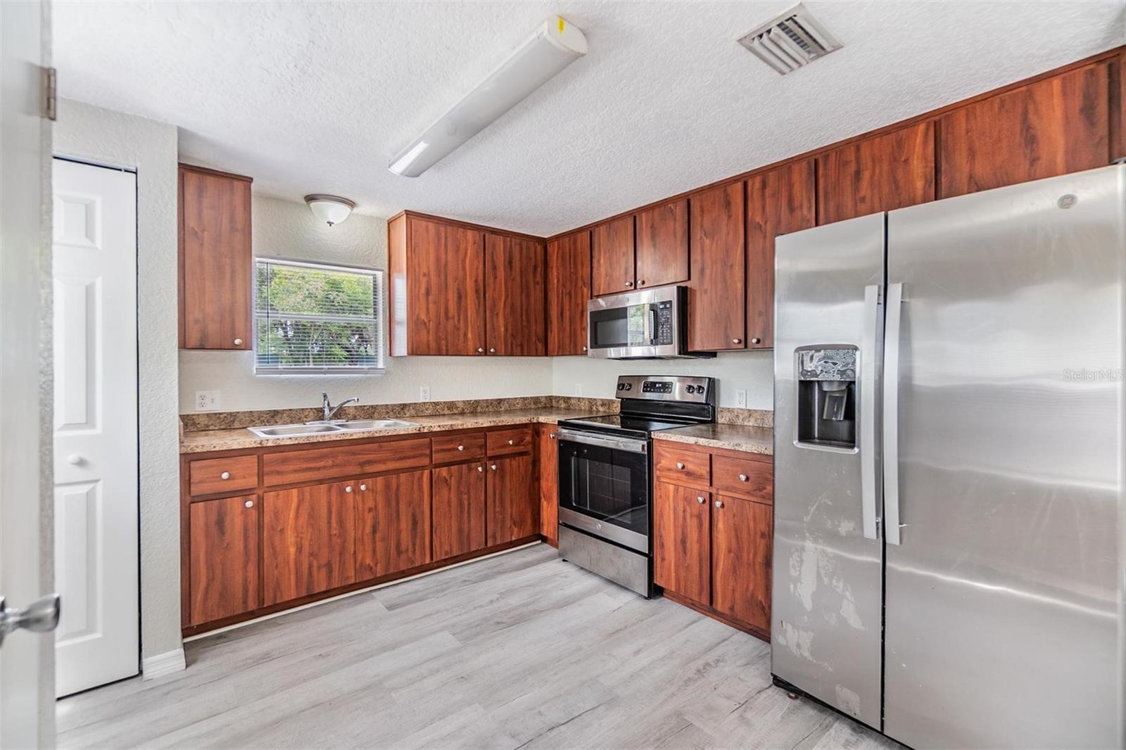 NEW LUX VINYL PLANK FLOORS. NO POPCORN CEILING.  DRYWALL ON WALLS.