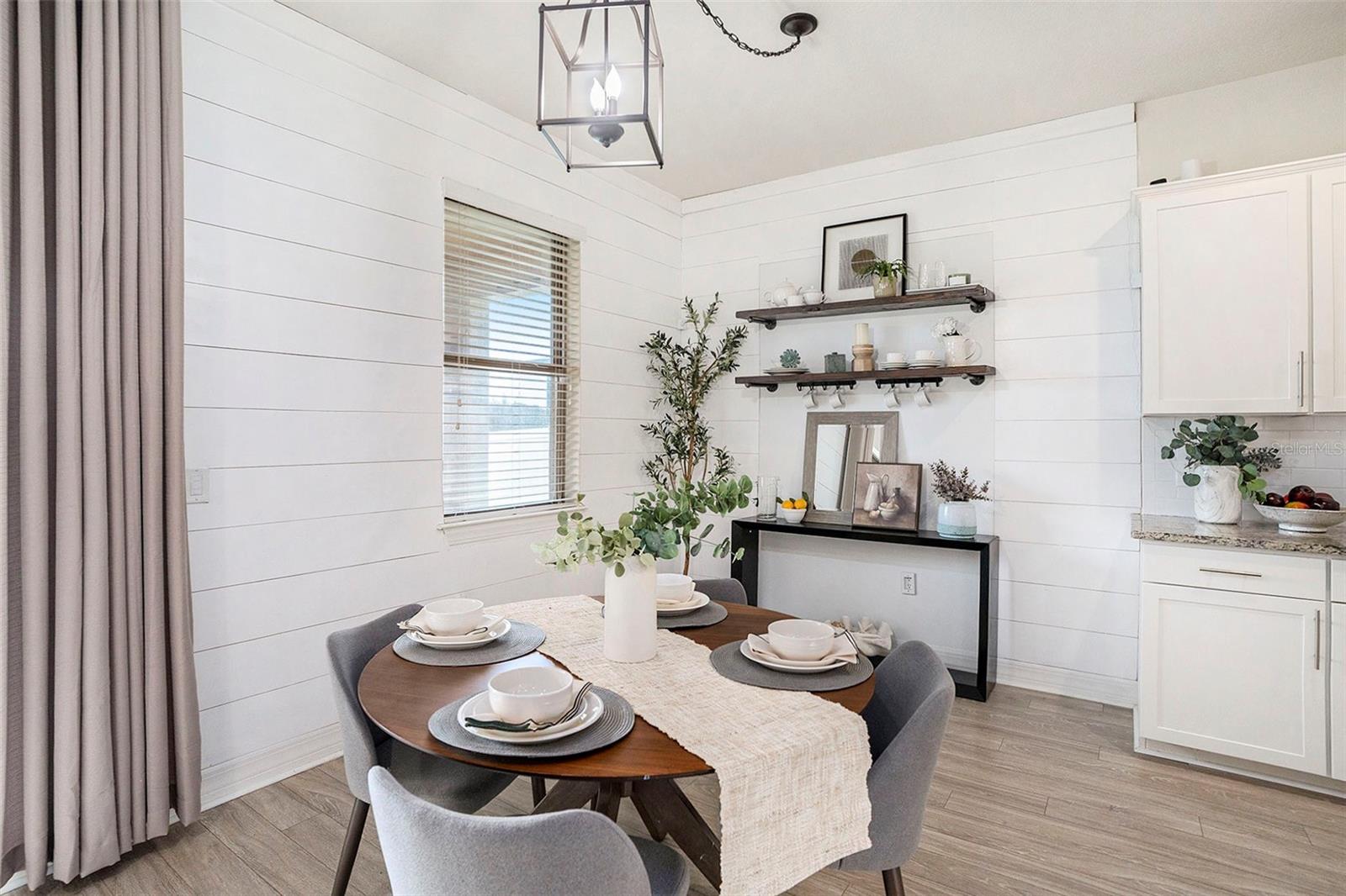 Eat in kitchen with ship lap wall accents and extra shelving