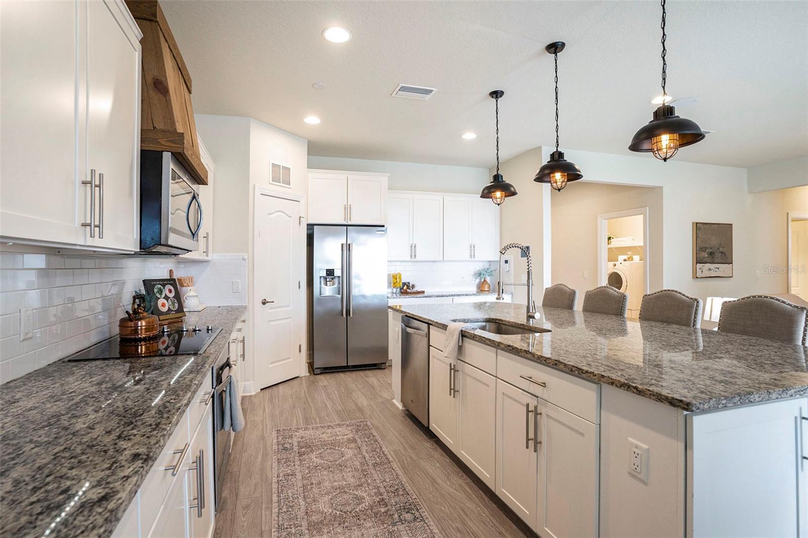 Stainless steel appliances, extra space in both kitchen and great room, an abundance of light and stunning subway tile backsplash