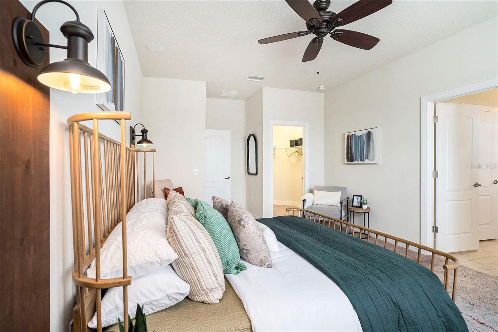 Primary bedroom has it all: huge walk in closet and another closet in the bedroom, ceiling fans, large portrait window, and ensuite bathroom with a private water closet