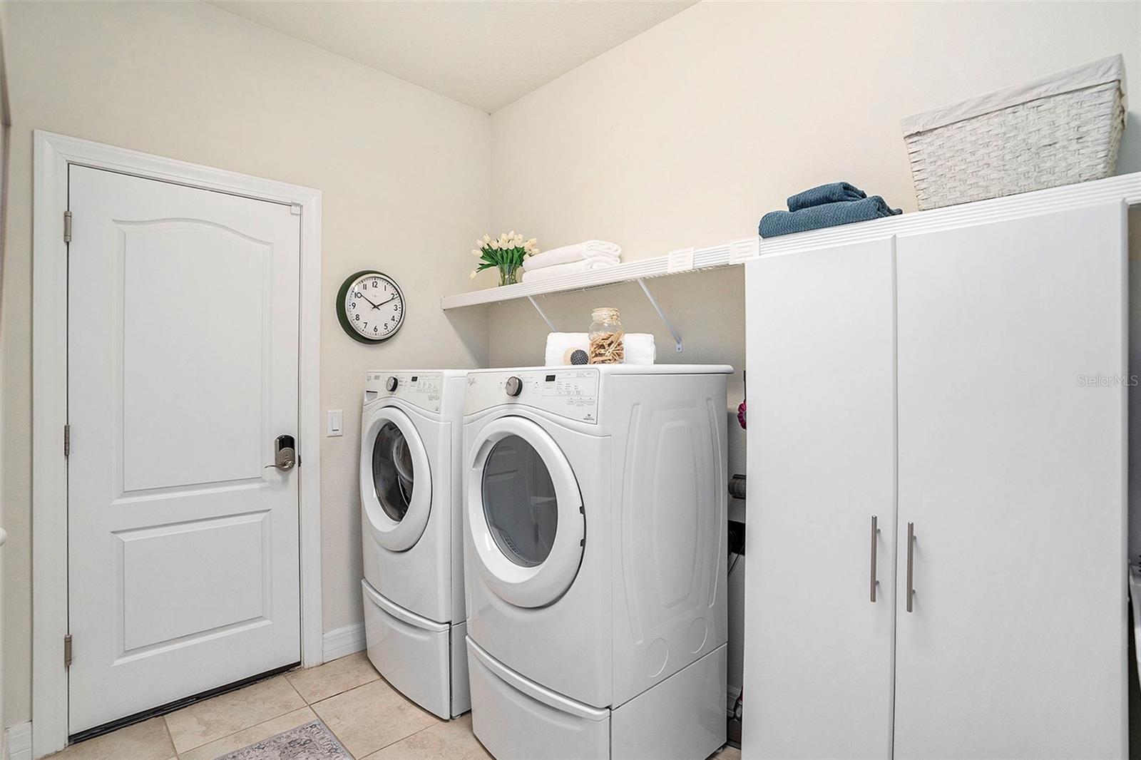 Large laundry room with storage closet and utility sink (not shown, right of closet)