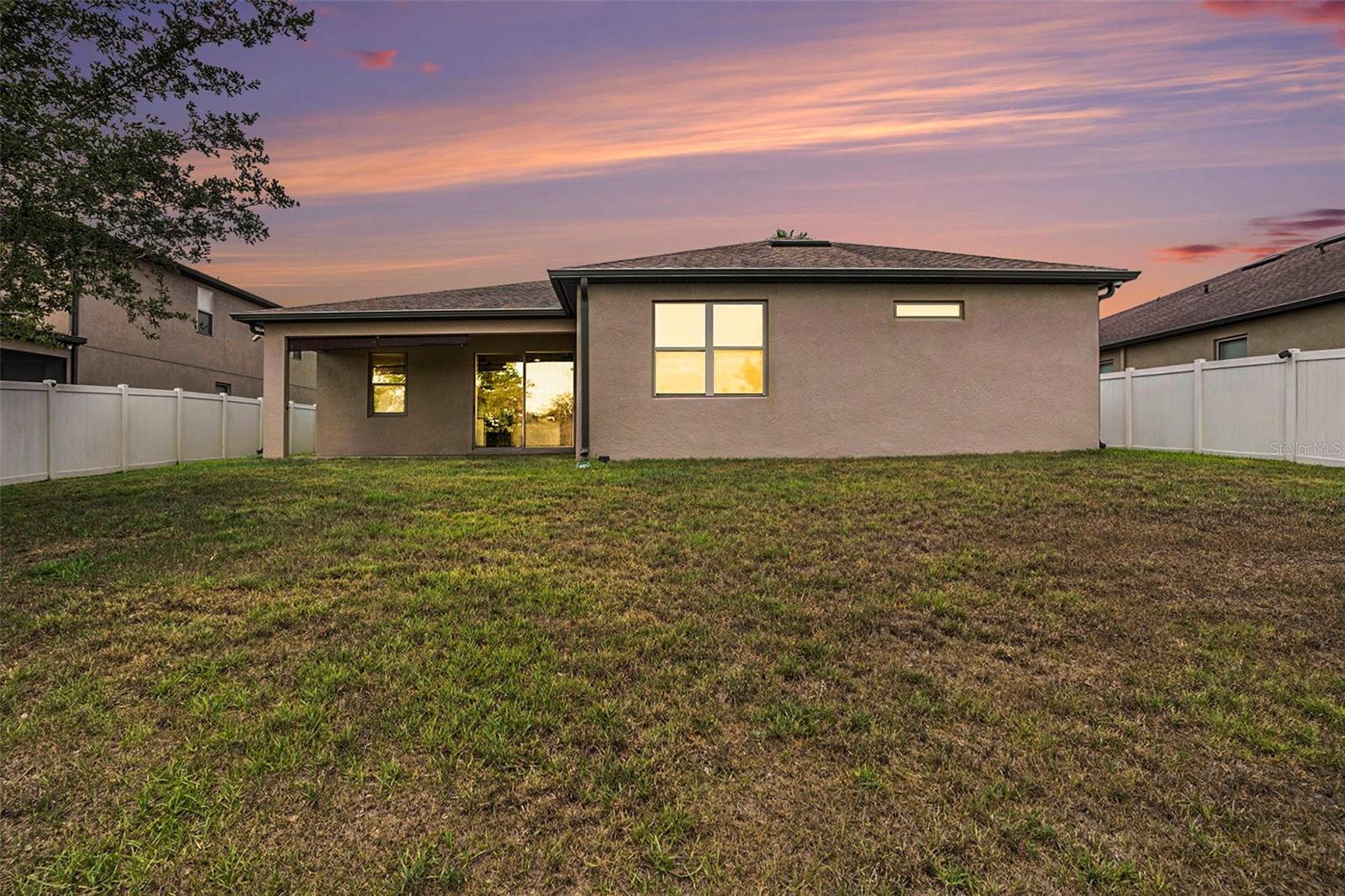 Covered outdoor back patio could be easily screened in.  Fully fenced yard with vinyl fencing.