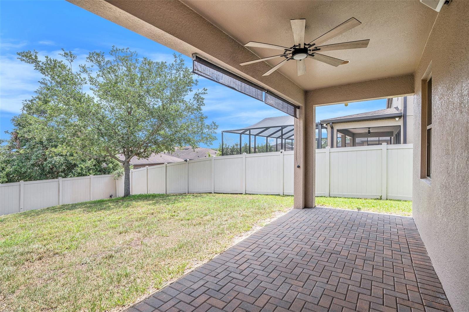 Covered patio accessible directly from the Great Room's large sliding doors.  Paved patio and ceiling fan offer a comfortable outdoor retreat!