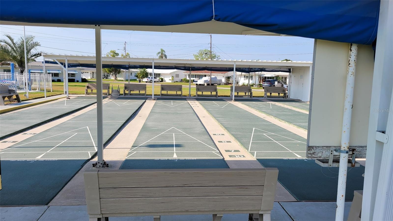 From this shuffleboard photo, you can see the house, just beyond the 2nd and 3rd benches from the left.