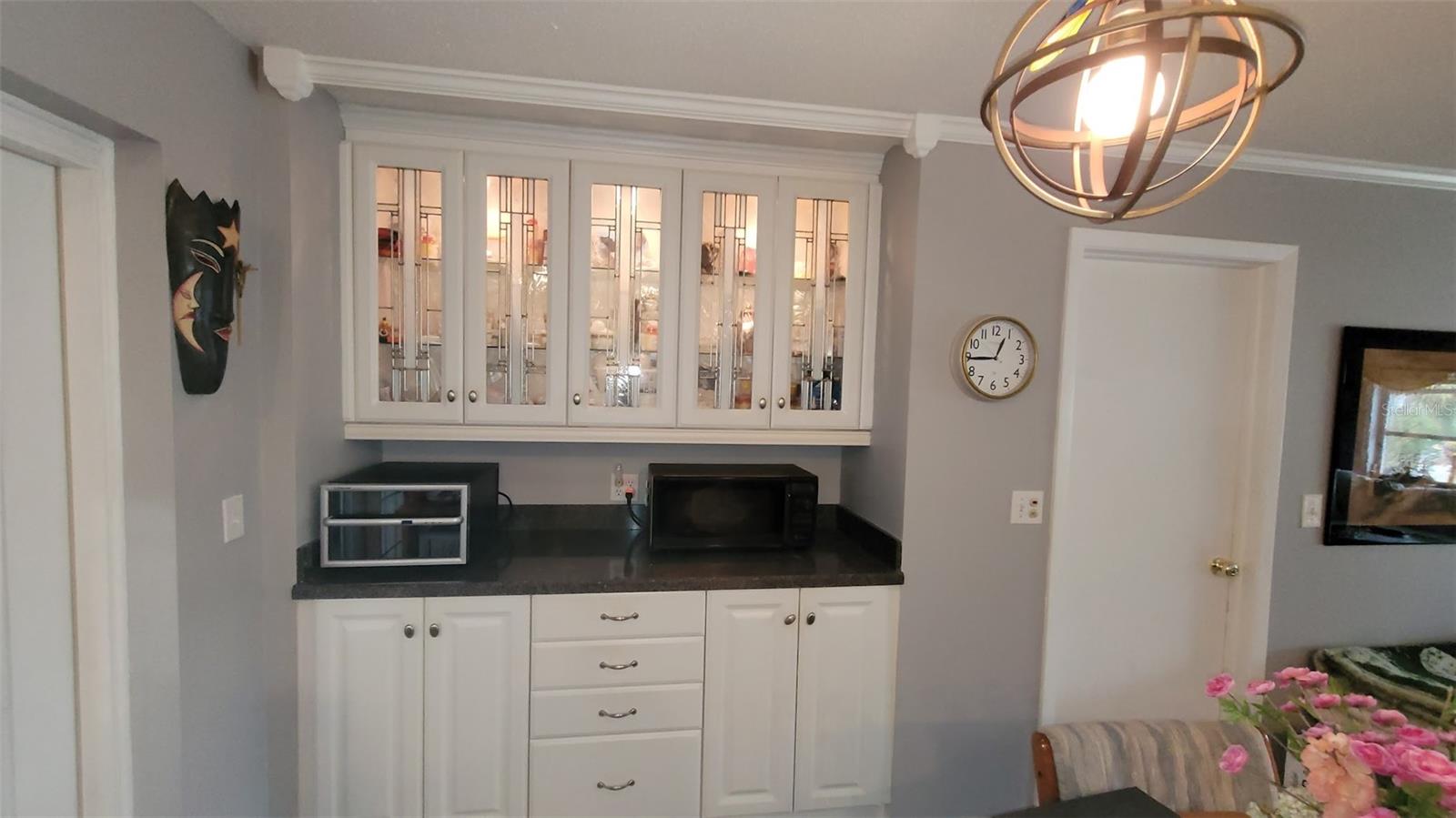 The right side of the kitchen has these beautiful lighted cabinets with additional counter space.