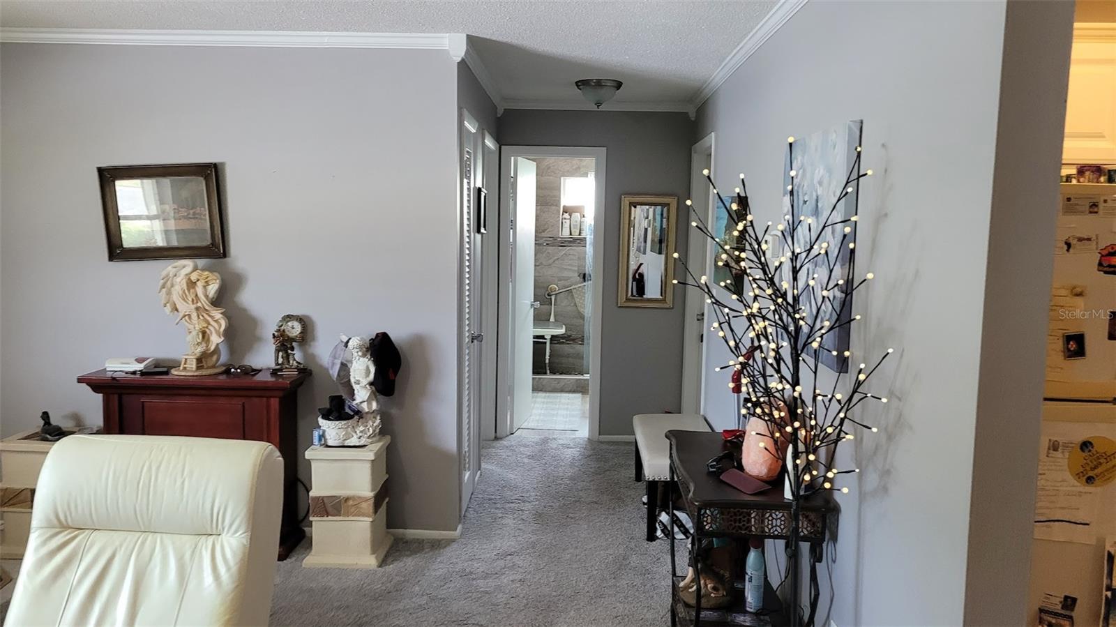 Leaving the kitchen and heading down the hall will take you to both bedrooms, the beautiful shower bathroom, and a linen closet.
