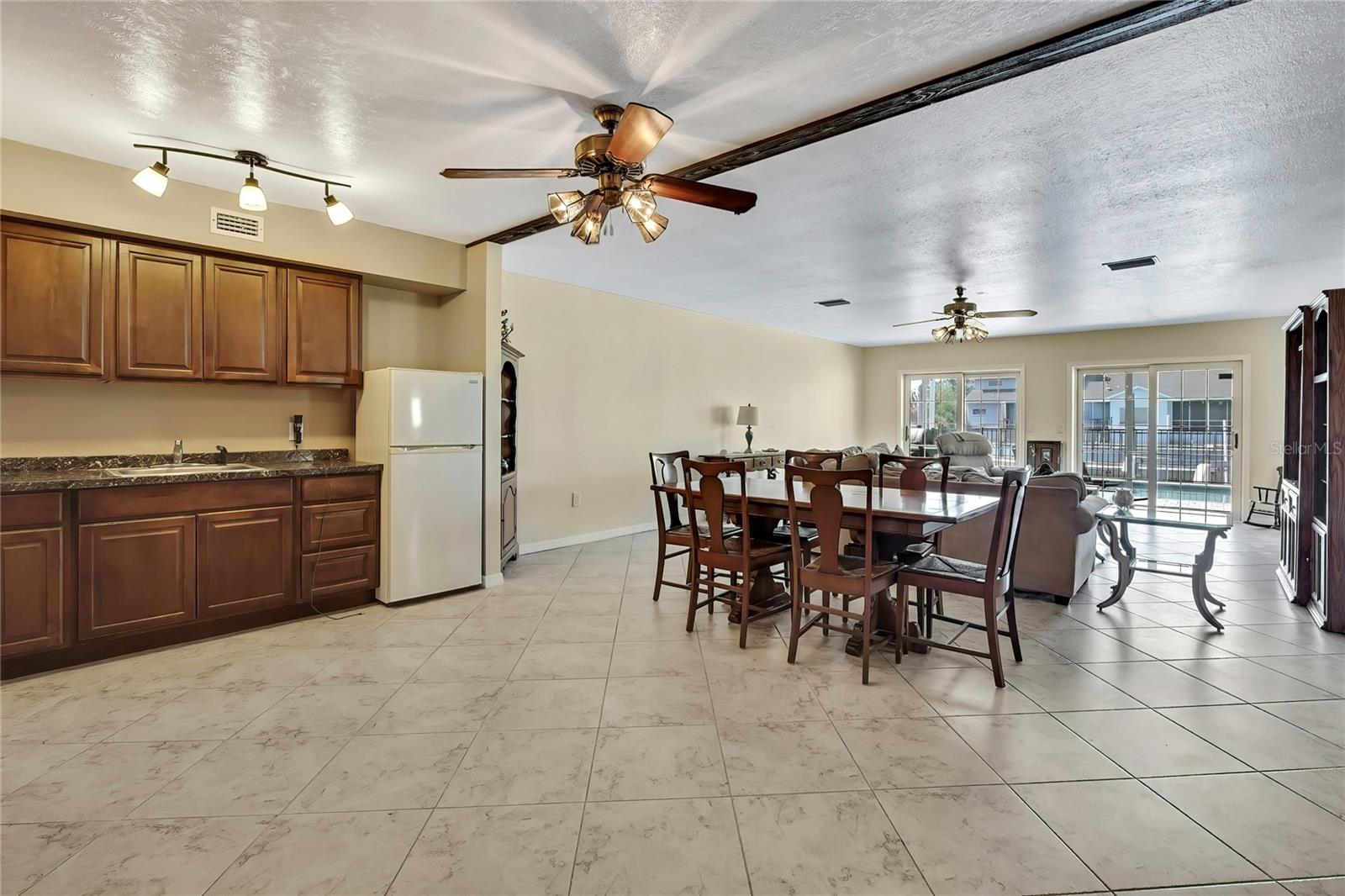 Ground floor kitchette, great room, walkout to pool deck