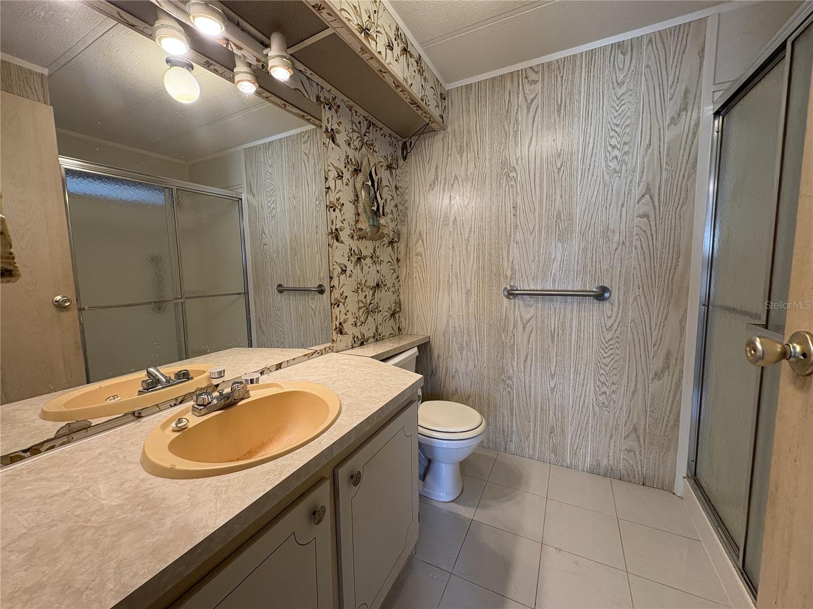 Primary bath ensuite with porcelain tile floors