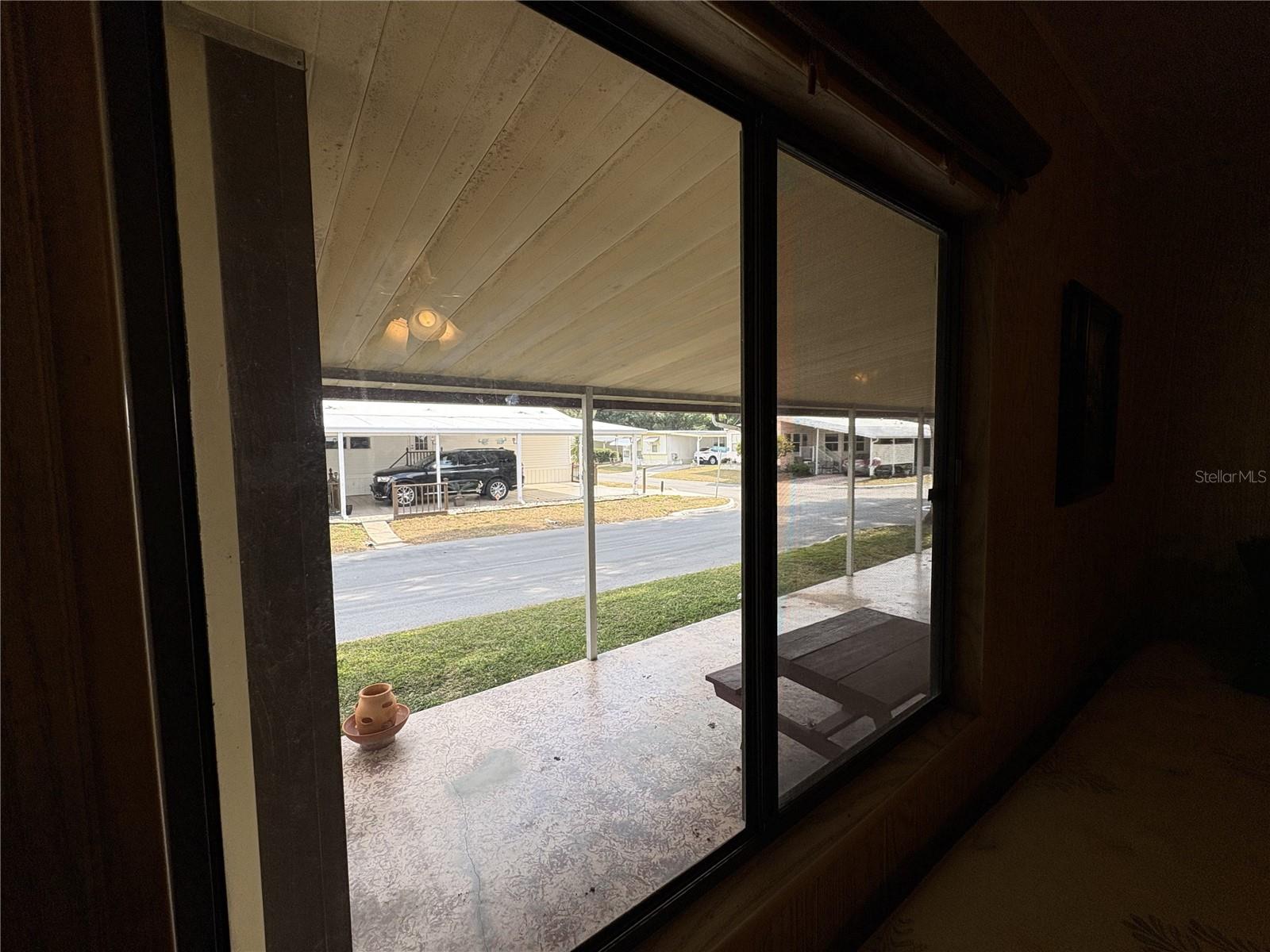 Double window in Guest bedroom overlooks carport