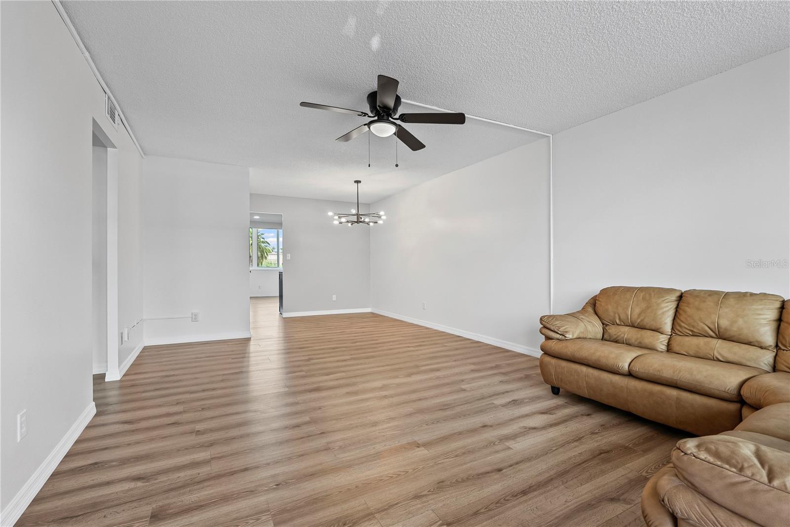Living room dining combo makes for nice natural lighting and an open feel