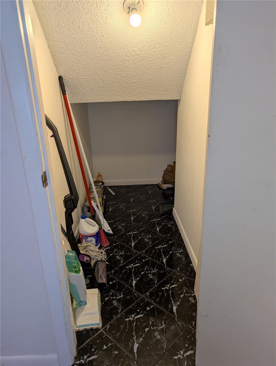 Utility and storage area under the stairs