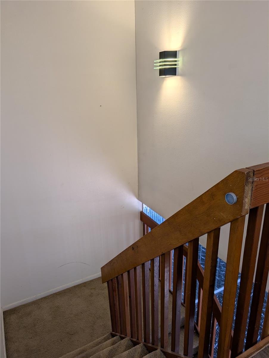 Top of the stairs looking down toward Kitchen and Living area.