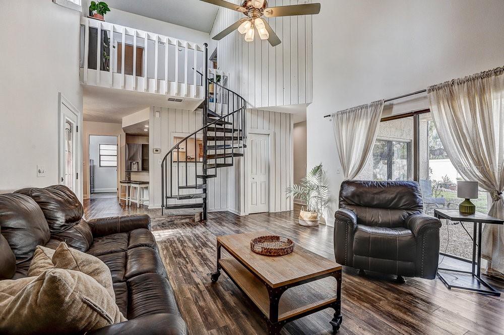 Living room view of the loft and stairs, overlooking the kitchen area