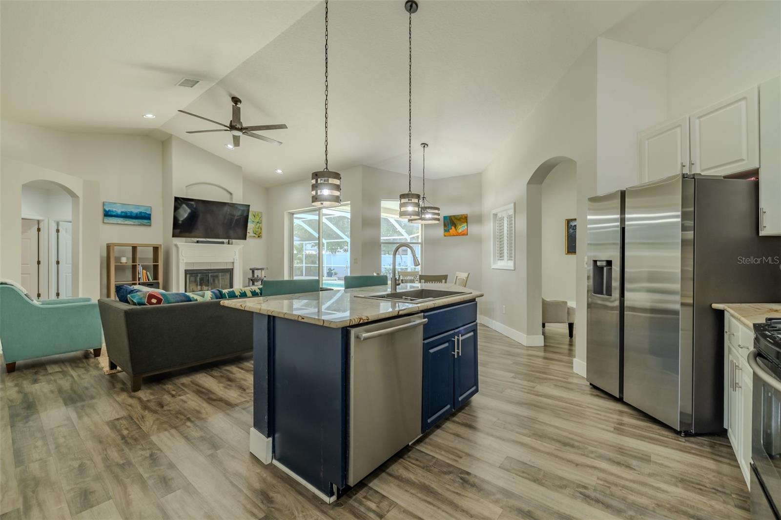 Kitchen overlooks Family Room with POOL views!