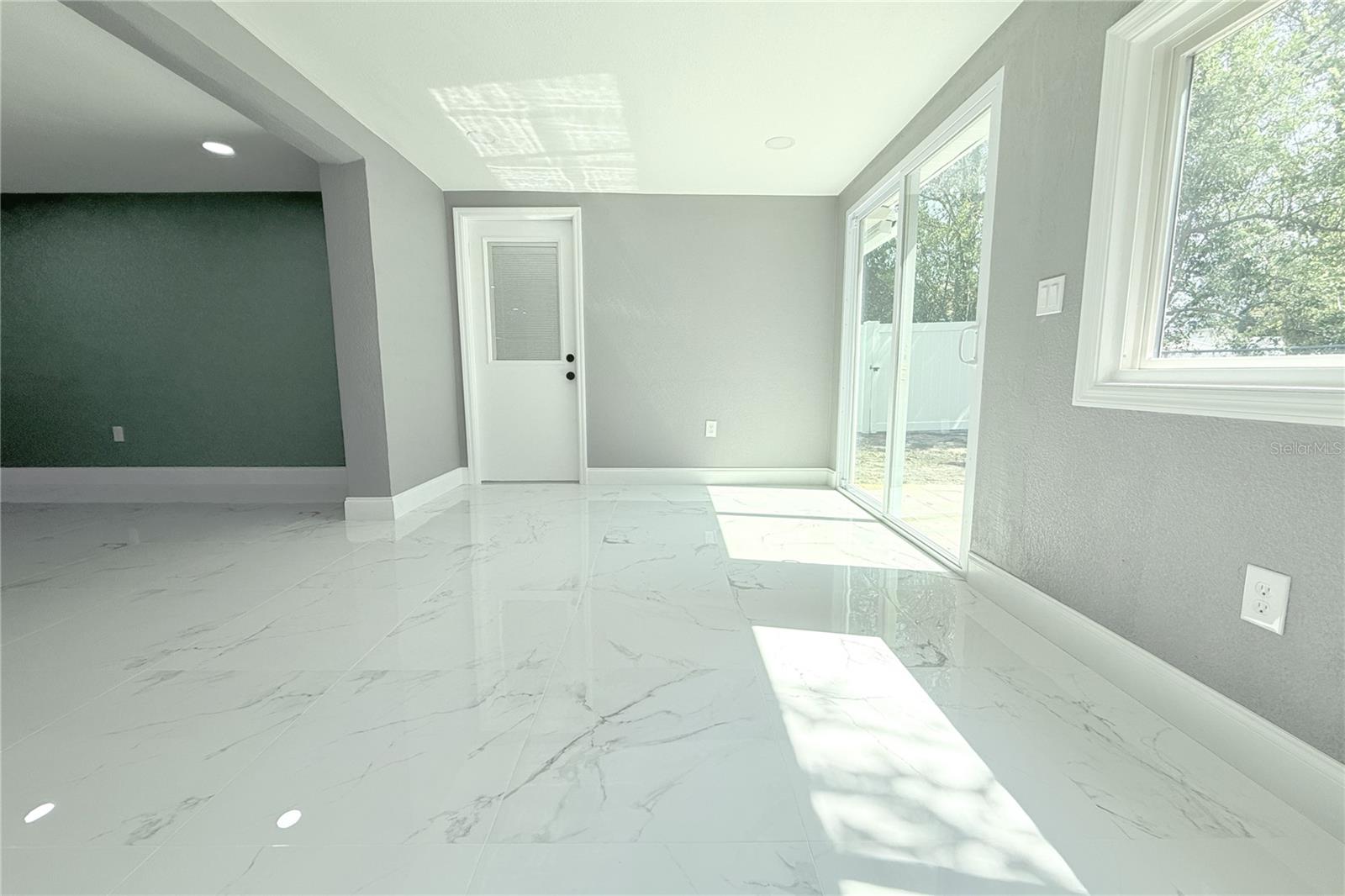 FAMILY ROOM ENTRANCES A BONUS ROOM AND BACKYARD