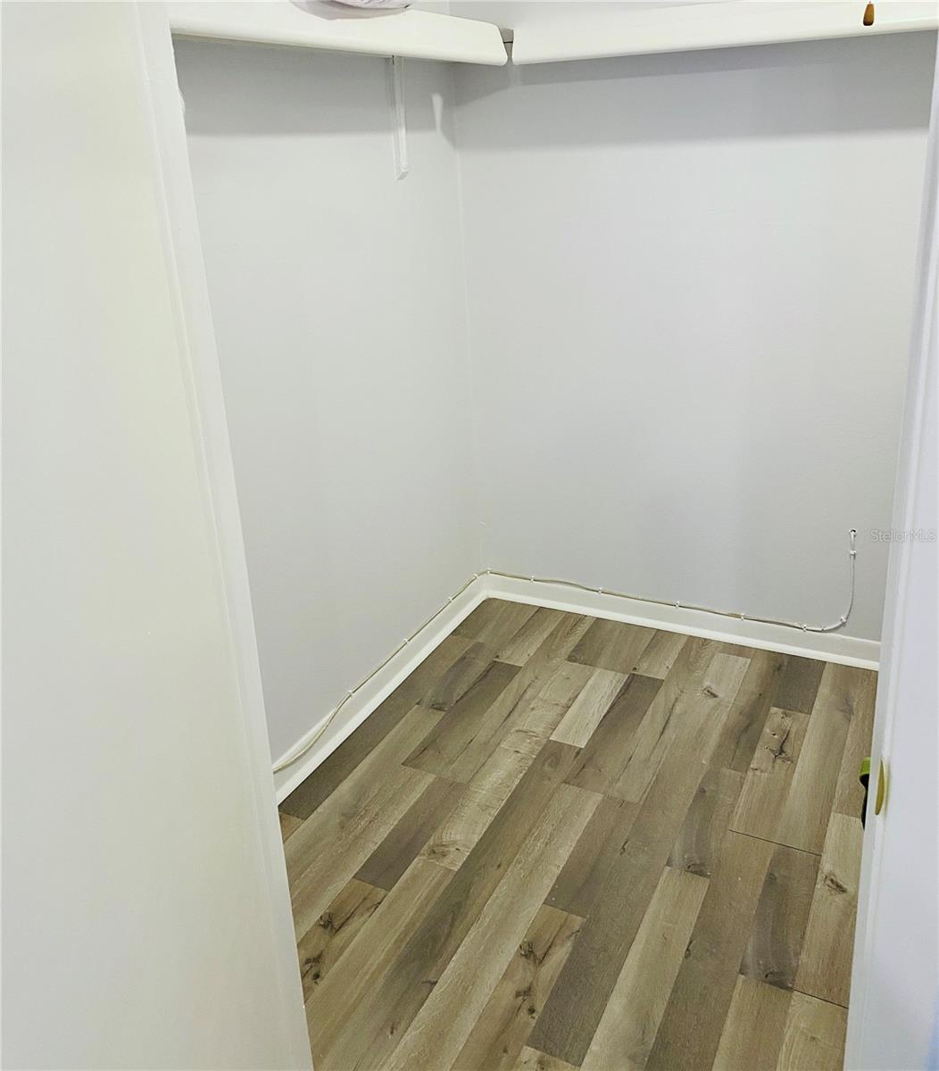 Primary bedroom walk in closet