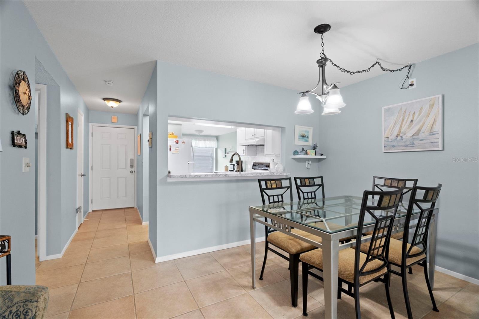 Dining room and kitchen bar view to front foyer