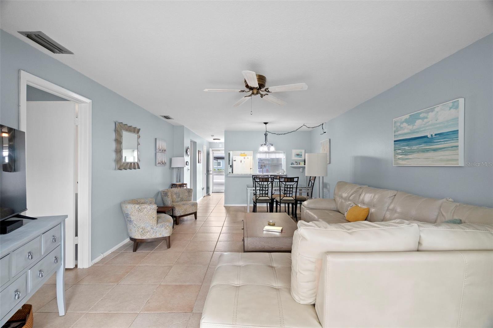 Bright and open family room with leather sectional for that coastal feel