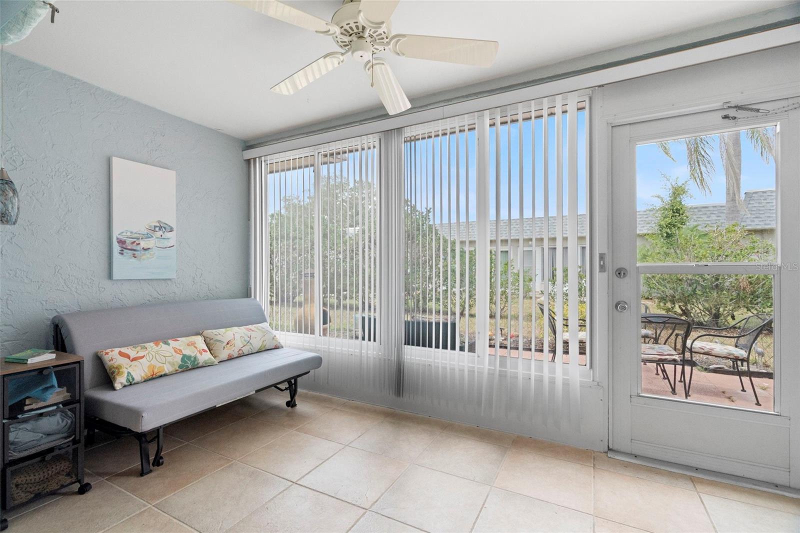 Enclosed lanai with futon and large windows